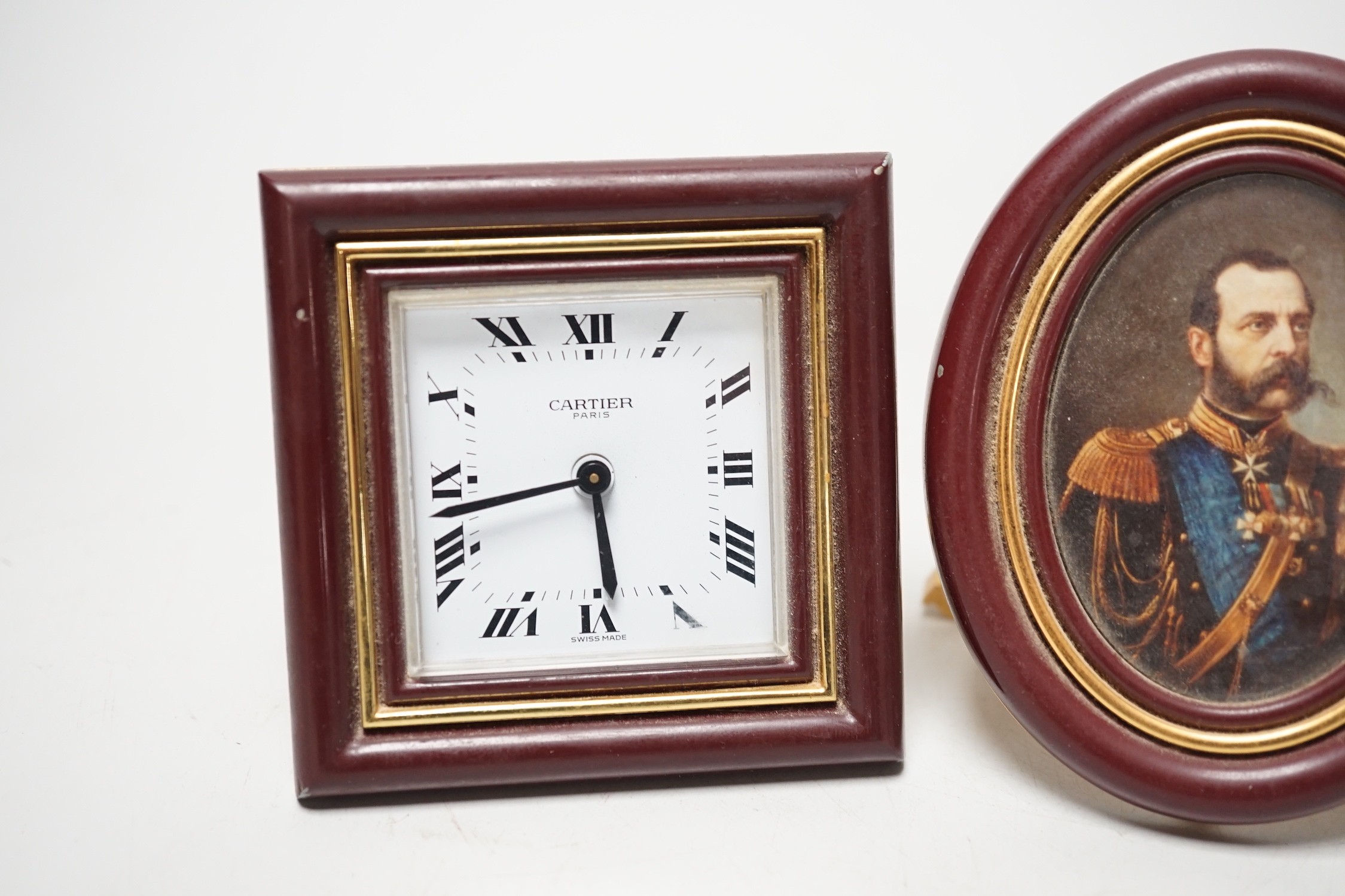 A Cartier travelling alarm timepiece and two Must de Cartier miniature frames